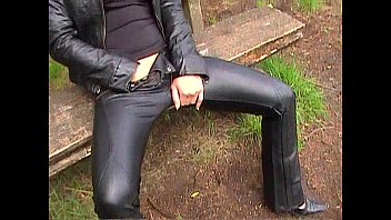 blondie in leather pants and leather jacket jerking outdoors