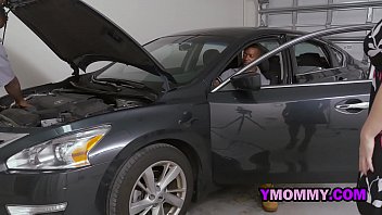 Horny milf blows on the mechanics as they fix her car