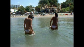 two beautiful ample-boobed gals on beach.